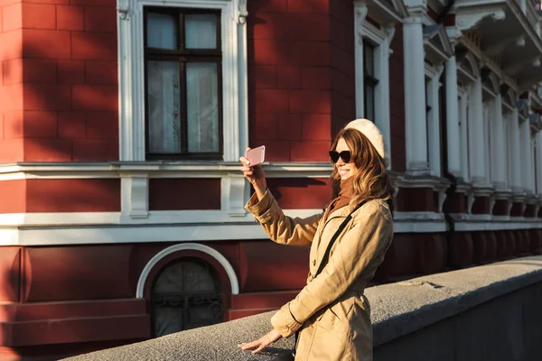 Lovely young woman wearing a coat walking — Stock Photo, Image