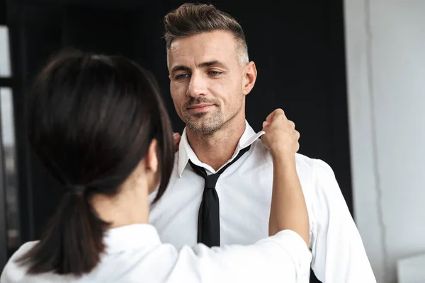 Woman help to her husband boyfriend with tie formal clothes indoors at home. — Stock Photo, Image