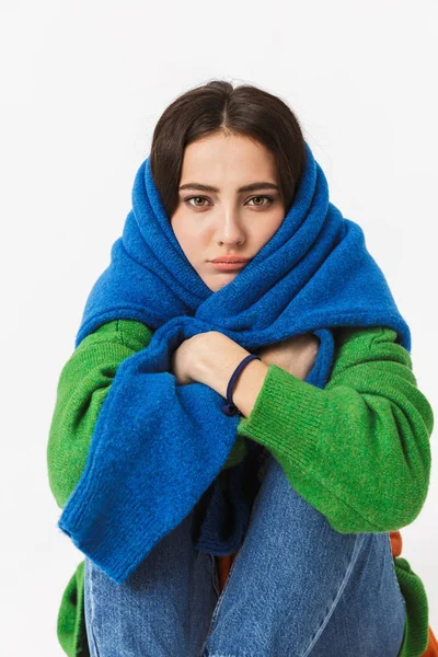 Photo of pretty woman 30s wrapped in colorful sweater sitting on — Stock Photo, Image