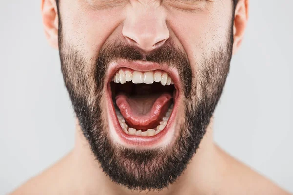 Close up half face portrait of a smiling bearded man