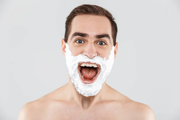 Portrait of a cheerful shirtless bearded man standing — Stock Photo, Image