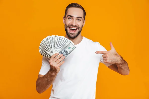 Foto de hombre sin afeitar de 30 años en ropa casual sosteniendo montón de dinero , —  Fotos de Stock