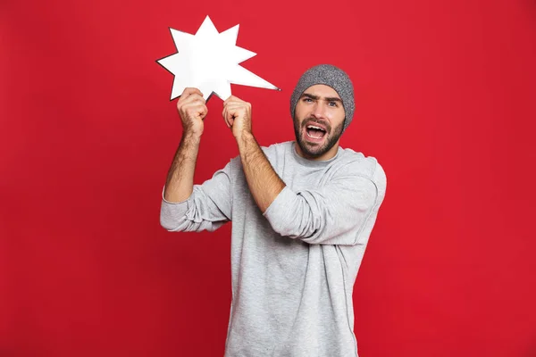 Imagen de un hombre alegre de 30 años con sombrero sosteniendo un póster de idea en blanco , —  Fotos de Stock