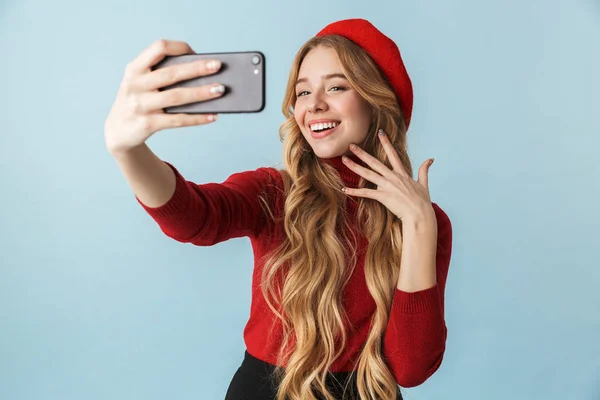Sevimli kız 20'li yaşlarda giyen kırmızı bere selfie mo üzerinde alarak fotoğraf — Stok fotoğraf