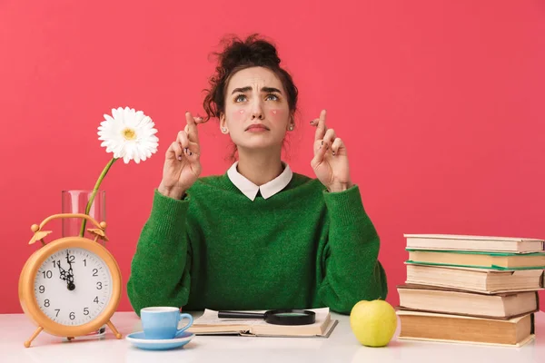 Beautiful young student girl sitting at the table — Stock Photo, Image