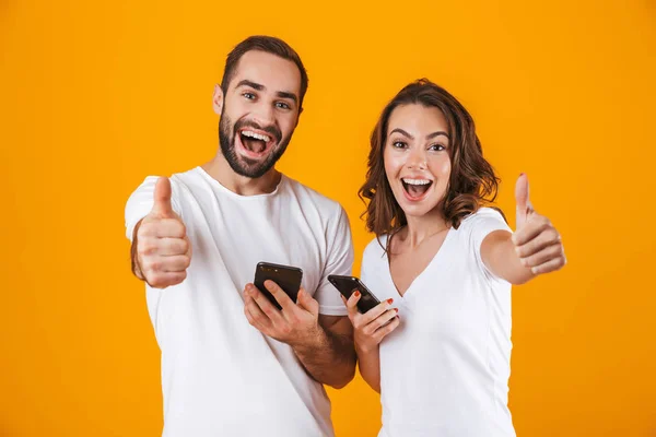 Bild von zufriedenen Paar Mann und Frau lächelnd, während beide mit m — Stockfoto