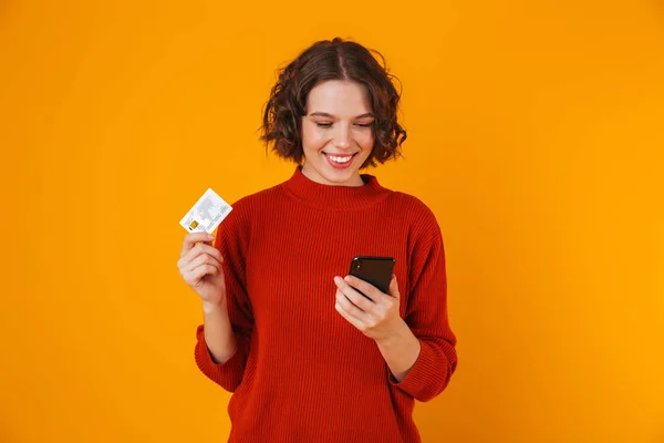 Porträt einer brünetten Frau mit Handy und Kreditkarte — Stockfoto