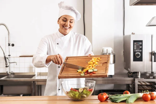 Photo of professional woman chef wearing white uniform making sa — Stock Photo, Image