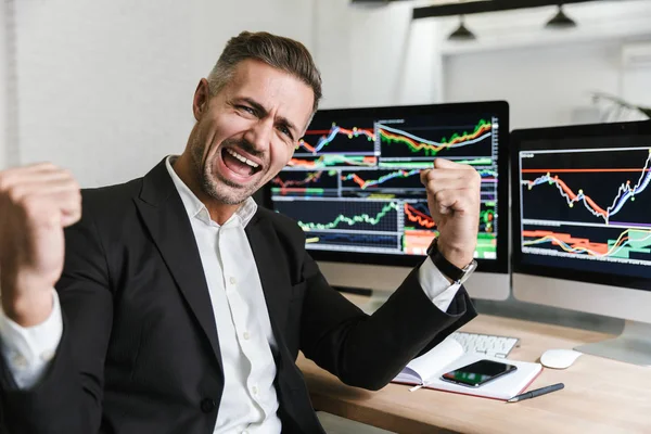 Photo of ecstatic businessman rejoicing while working in office — Stock Photo, Image