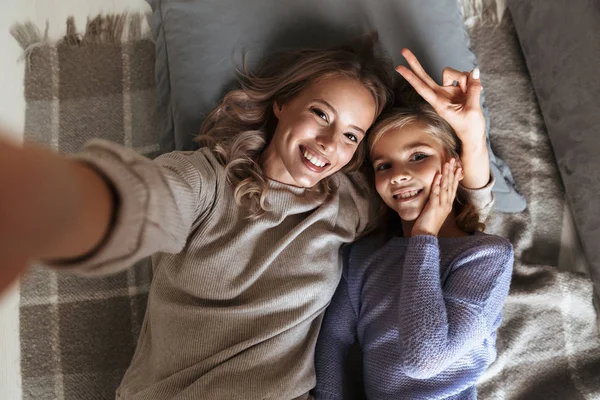 Küçük kız kardeşi olan mutlu kadın kapalı evde bir selfie kamera tarafından al. — Stok fotoğraf