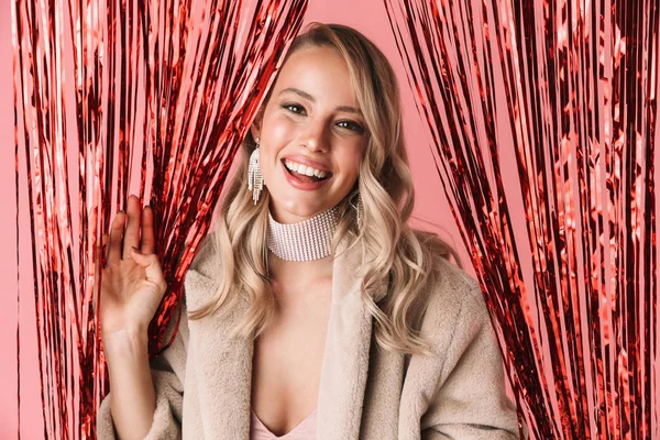 Beautiful happy excited young pretty woman posing isolated over pink wall background wearing accessories and jewelry over holiday decor. — Stock Photo, Image