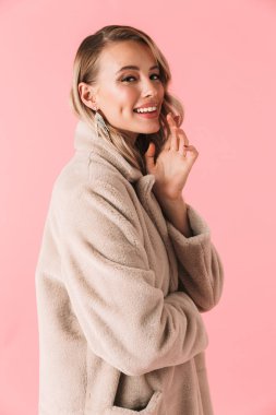 Güzel kadın Aksesuar ve takı takan pembe duvar arka plan üzerinde izole poz.