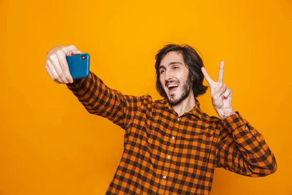 Photo of hairy man wearing plaid shirt having fun and taking sel