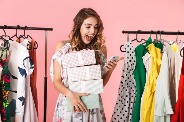 Photo of attractive woman with purchase standing in store near c — Stock Photo, Image