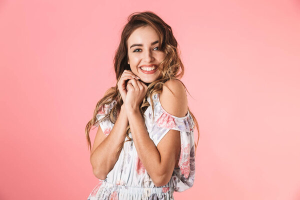 Image of adorable woman 20s wearing dress smiling and looking at