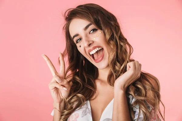 Imagem de mulher divertida 20s vestindo vestido sorrindo e mostrando ervilha — Fotografia de Stock