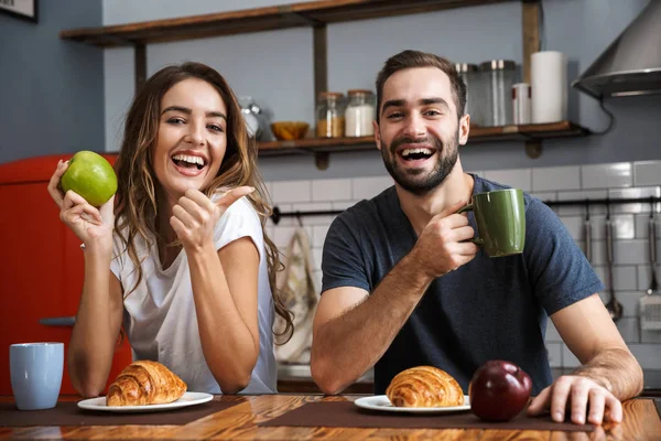 Beautiful cheerful couple having breakfast — Stock Photo, Image