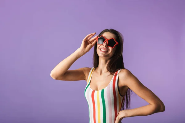 Cheerful young girl wearing swimsuit standing — Stock Photo, Image