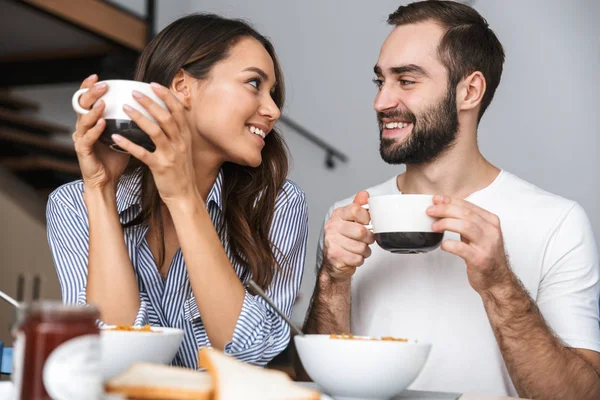 Happy young couple having breakfast — Stock Photo, Image