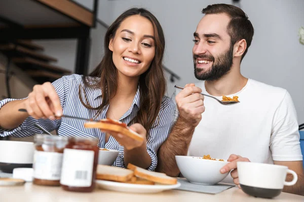 Happy multiethnic couple having breakfast — Stock Photo, Image