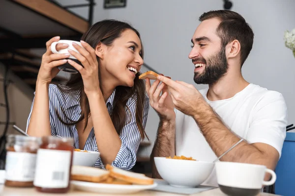 Happy multiethnic couple having breakfast — Stock Photo, Image