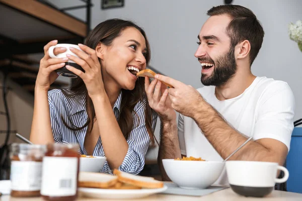 Happy multiethnic couple having breakfast — Stock Photo, Image