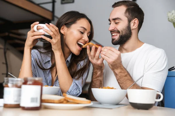 Happy multiethnic couple having breakfast — Stock Photo, Image