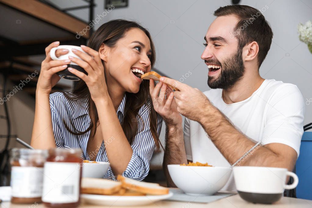 Happy multiethnic couple having breakfast