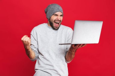 Gümüş dizüstü tutarken sevindirici iyimser adam portresi