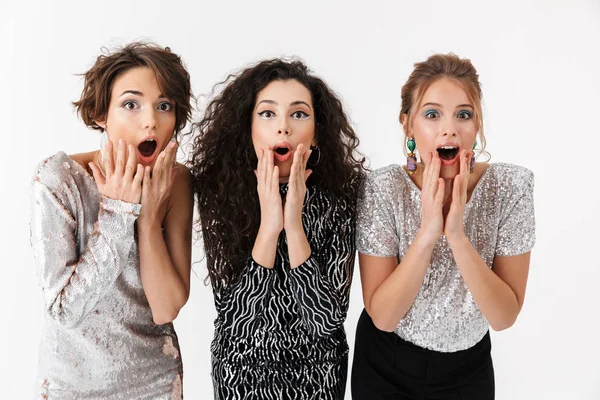 Shocked women friends posing isolated over white wall background on a party. — Stock Photo, Image
