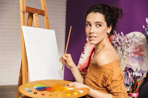 Creative beautiful woman painting at home — Stok Foto