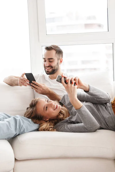 Amazing loving couple sitting indoors at home watch TV. — Stock Photo, Image