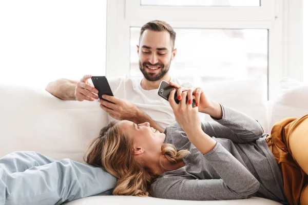 Amazing loving couple sitting indoors at home watch TV. — Stock Photo, Image