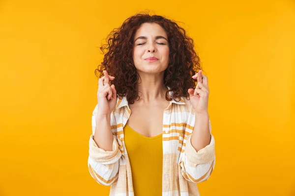 Image of trendy woman 20s with curly hair keeping fingers crosse — Stock Photo, Image