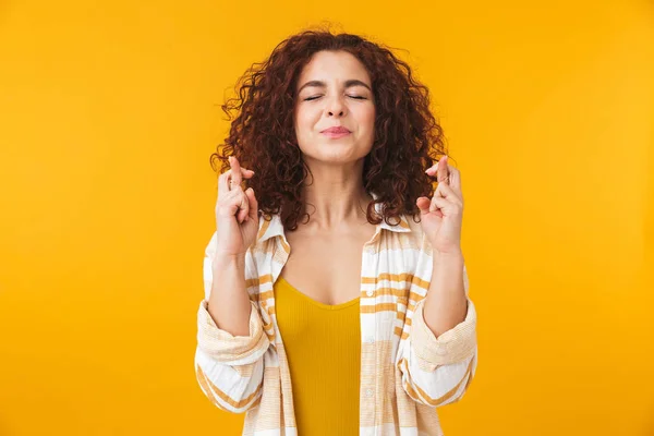 Imagen de mujer de moda de 20 años con el pelo rizado manteniendo los dedos cruzados — Foto de Stock