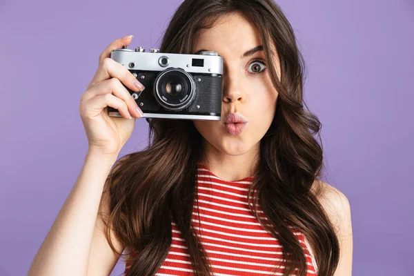 Feliz jovem mulher bonita fotógrafo posando isolado sobre roxo fundo parede segurando câmera . — Fotografia de Stock