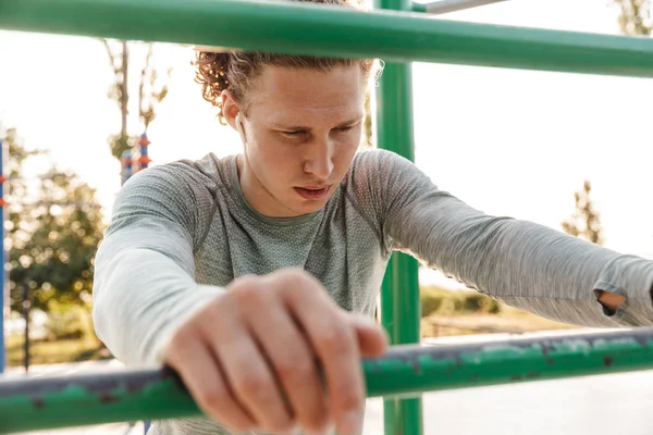 Jovem desportista confiante fazendo exercícios — Fotografia de Stock