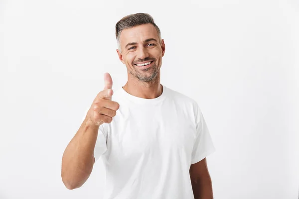 Image of happy man 30s with bristle wearing casual t-shirt showi — Stock Photo, Image