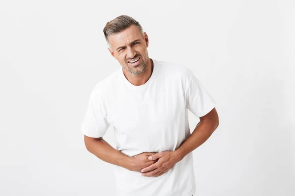 Image of tense man 30s with bristle wearing casual t-shirt touch — Stock Photo, Image