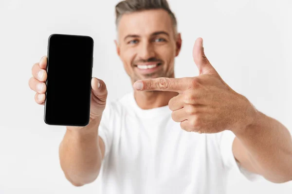 Image of successful man 30s wearing casual t-shirt holding and d — Stock Photo, Image