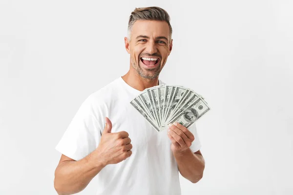 Image of muscular man 30s wearing casual t-shirt smiling and hol — Stock Photo, Image