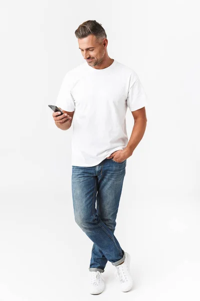 Full length image of brunette man 30s wearing casual t-shirt and — Stock Photo, Image