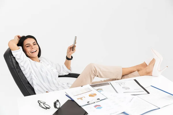 Photo of happy brunette businesswoman 30s holding and using smar — Stock Photo, Image