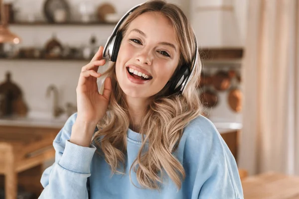 Portrait of european blond girl 20s wearing headphones listening — Stock Photo, Image