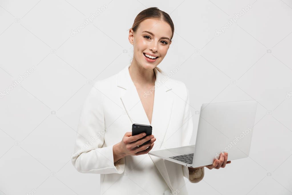 Photo of pretty businesswoman 20s wearing elegant jacket smiling