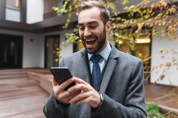 Attractive young businessman wearing suit walking — Stock Photo, Image