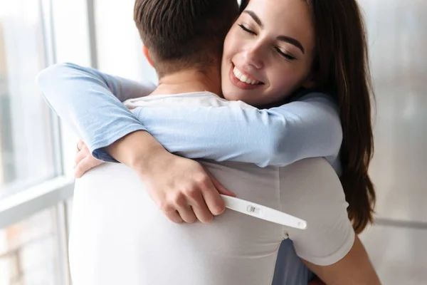 Bella giovane coppia holdingpregnancy test — Foto Stock