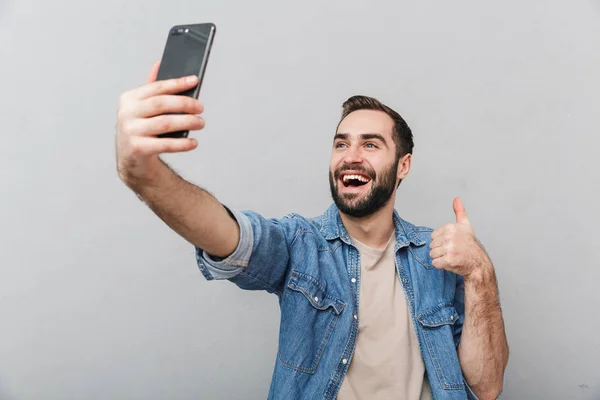 Excited cheerful man wearing shirt standing isolated — Stock Photo, Image