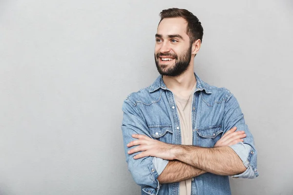 Excited cheerful man wearing shirt standing isolated