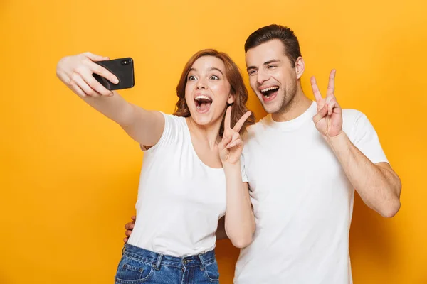 Portrait of a cheerful young couple standing — Stock Photo, Image